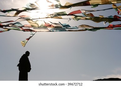 Monk Silhouette And Tibet Buddhist Flag