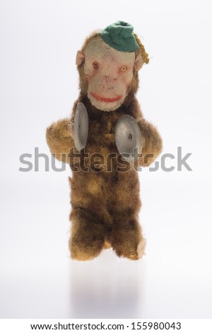 monkey with cymbal in front of white background