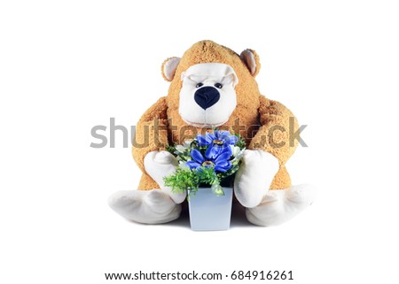 the  monkey doll hold a white pot with purple flowers