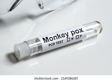 Monkey pox test tube on white table close-up. Medical kit for monkeypox virus diagnostics and smallpox research. Concept of monkey pox, PCR testing, result, science, laboratory, health and cure. - Shutterstock ID 2169286287