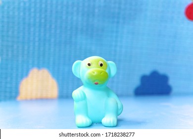 Monkey rubber toy in blue background of shallow Dof with copy space