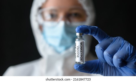 Monkeypox vaccine in doctors hand, scientist in personal protective equipment (PPE) shows bottle for shot from smallpox in lab. Concept of vaccine, monkey pox virus, treatment, health and injection. - Shutterstock ID 2161847723