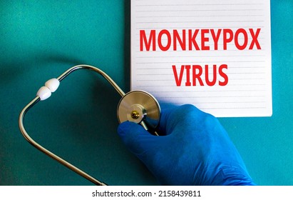 Monkeypox virus symbol. Concept words Monkeypox virus on white note. Stethoscope. Doctor hand in blue glove with white note. Medical and Monkeypox virus concept. Copy space.