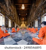 Monks performing rituals in the church of Wat Suthat