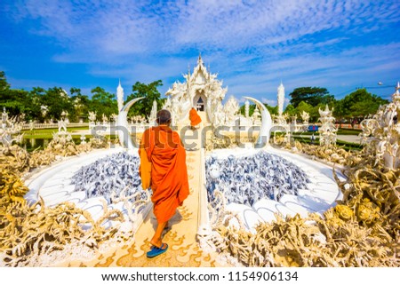 Monks visiting white temple Wat Rong Khun temple in Chiang Rai, Thailand in Asia