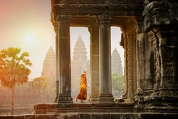 Monks Walk On The Balcony To See The Stone Carving At Sunset Of Angkor Wat.