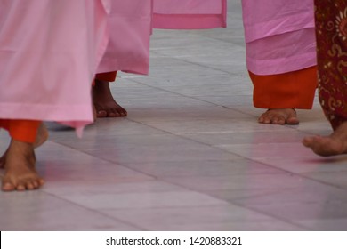 Monks Walking Barefoot Inside The Temple In Mandalay, Burma.