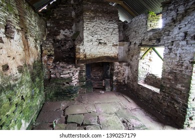 Monmouthshire, Wales, Britain, February 2017, Interior Of Derelict Farm Cottage With Old Fire Place And Stone Flag Floor