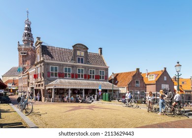 Monnickendam, The Netherlands on May 28, 2021; People on the terrace of a cafe in the former weigh house in the small picturesque fishing village of Monnickendam.
