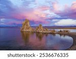 Mono Lake along Highway 395, with tufa towers mirrored in the lake’s glassy surface, reflecting the soft purples of dusk.