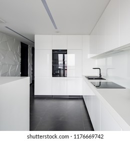 Monochromatic Designed White Kitchen With Modern Equipment And Black Flooring