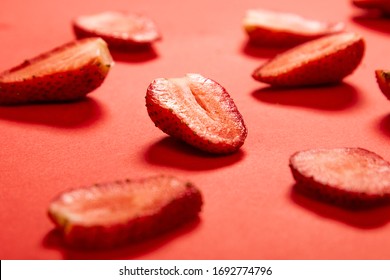 Monochromatic Food Pattern Made Of Sliced Strawberries On Red Surface In Perspective