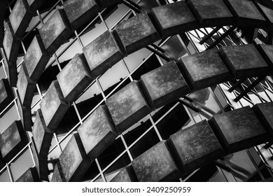 Monochromatic geometric pattern of building facade creating a dynamic play of light and shadow