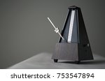 Monochromatic metronome in action isolated and on a plain background