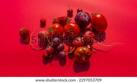 monochromatic red vegetable and fruit distributed still life