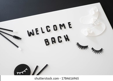 Monochrome Beauty Background Concept.  Lash Artist Related Beauty Treatment Products Arranged Around The Words Welcome Back