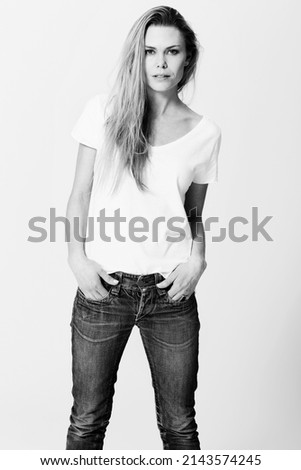 Monochrome chic. Croppy studio portrait of a an attractive young woman standing with her hands in her pockets. Stock photo © 