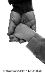 Monochrome closeup of an adult hand holding a child's hand on white