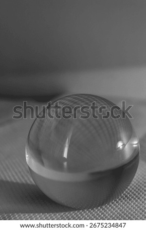 Monochrome crystal sphere refracts a pattern, symbolizing foresight and clarity. Elegant abstract concept for business or technology, with ample copy space for your message.