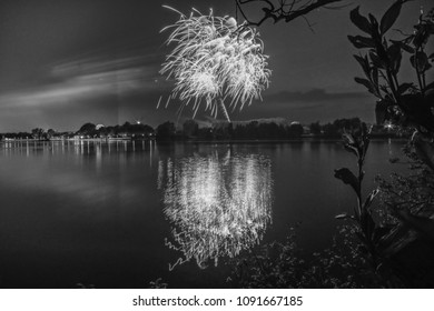 Monochrome fireworks  over a lake in front of a city - Powered by Shutterstock