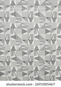 Monochrome geometric seamless pattern of triangles and squares filled with varying striped textures. 