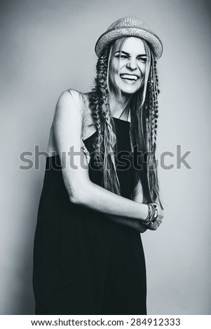 monochrome happy laughing woman in overall and hat in studio