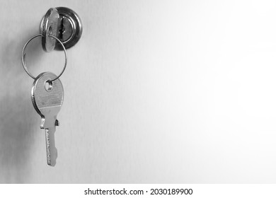 Monochrome image of a key in a keyhole. Key on a white background. Keyhole blending into a white background. - Powered by Shutterstock