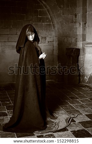 Monochrome image of a medieval castle and a gothic woman