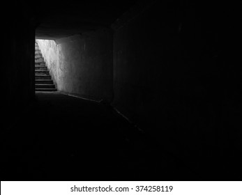Monochrome image of stairs exiting from a tunnel