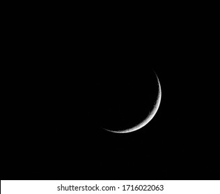 A Monochrome Image Of A Thin Crescent Moon