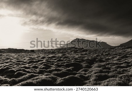 Monochrome lava field with dramatic clouds on Snæfellsnes Peninsula, Iceland.