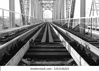 Monochrome Photo Of The Bridge On The Railroad Tracks And Industrial Gray Stone