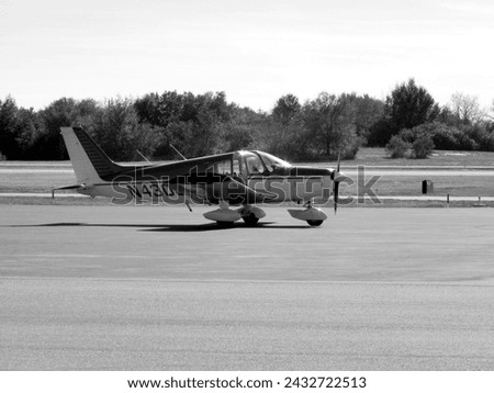 A monochrome photograph of civilian  airplanes in action at the Winter Haven, Florida Airport. 