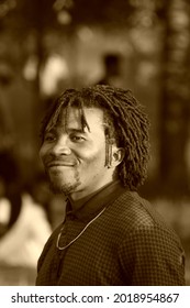 Monochrome Photography. Portrait Of A Middle-aged African Man With A Traditional Hairstyle. Representative Of The Negroid Race, Originally From Cameroon. 