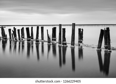 Monochrome Photography In Vintage Style With Old Wooden Trunks In Water In Long Exposure In Ukraine