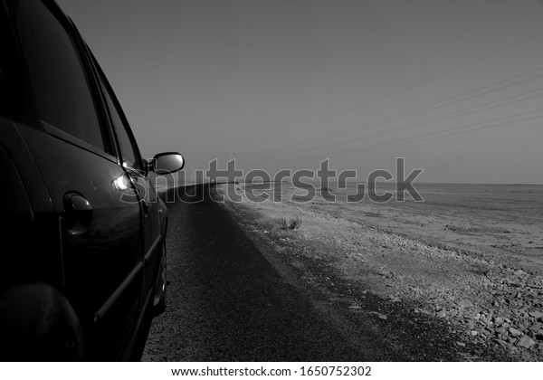 Monochrome picture of Car on\
the road