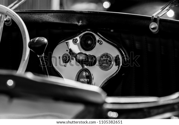 Monochrome picture of vintage car showing close\
up view of car\
dashboard