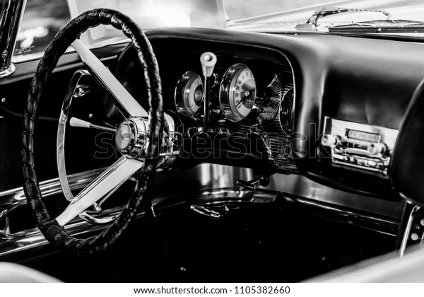 Monochrome picture of vintage car showing close\
up view of car\
dashboard