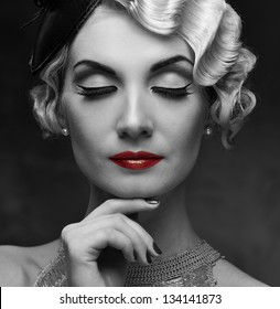 Monochrome portrait of elegant blond retro woman   with beautiful hairdo and red lipstick