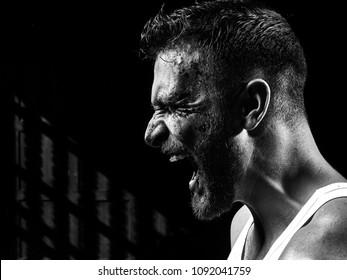 Monochrome Portrait Of A Strong Man With A Beard, Face In Blood. He Looks At The Camera With Different Emotions. Blood And Sweat Dripping Down His Face.