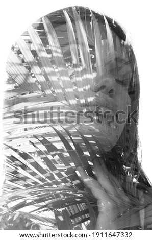 A monochrome portrait of a woman with closed eyes combined with a photo of palm leaves in a double exposure technique on white background