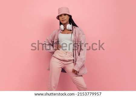 Monochrome portrait of young attractive happy woman in casual style outfit isolated on pink background. Concept of beauty, art, fashion, youth, sales and ads. Looks happy, delighted. Copy space for ad