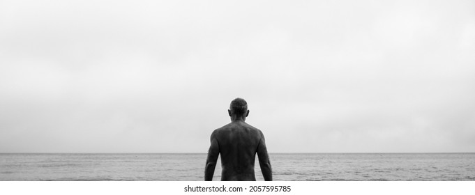 Monochrome Of Rear View Of Shirtless Man On Beach