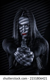 Monochrome Toned Shot Of A Beautiful Hitwoman With A Gun