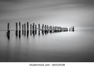 Monochrome weathered old dock pilllars
