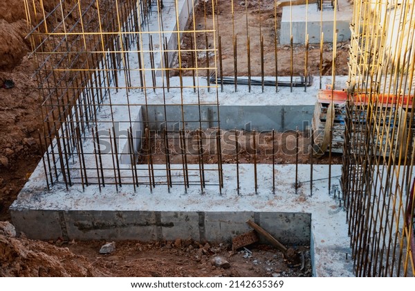 Monolithic foundation with metal\
reinforcement. Forms vertical formwork structures for the basement\
of a residential building. Monolithic concrete foundation. Support\
foundation. Home\
construction