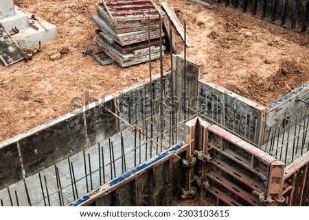 Monolithic reinforced concrete foundations for the construction of a large building. Rostverk at the construction site. Construction pit with foundation. Close-up