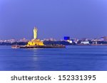 monolithic statue of the Gautam Buddha in the middle of the lake Hussain Sagar and Hyderabad city skyline, Hyderabad, India
