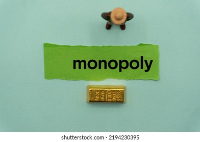 monopoly.The word is written on a slip of paper,on colored background. professional terms of finance, business words, economic phrases. concept of economy.