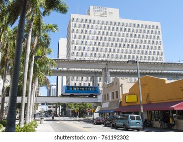 The Monorail Passing By Above The Street In Miami Downtown (Florida).